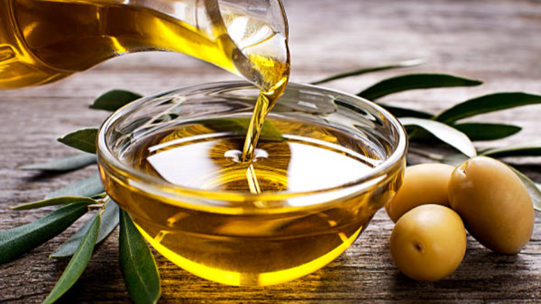 “Extra-virgin olive oil poured into a bowl, a heart-healthy Mediterranean ingredient recommended for adults over 50.”