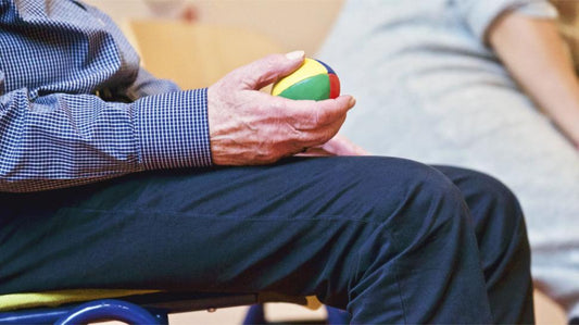 Older adult hand squeezing therapy ball for grip strength”.