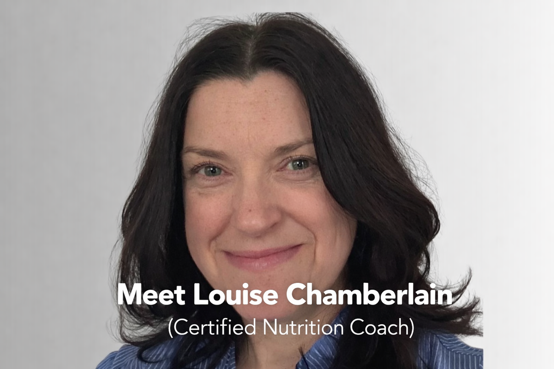 Portrait of nutrition coach Louise Chamberlain with dark hair, smiling softly at the camera.