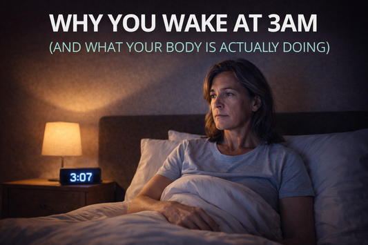 Middle-aged woman sitting awake in bed at 3:07am with a bedside lamp glowing, reflecting on sleep disruption and midlife waking patterns, with title “Why You Wake at 3am (And What Your Body Is Actually Doing)”